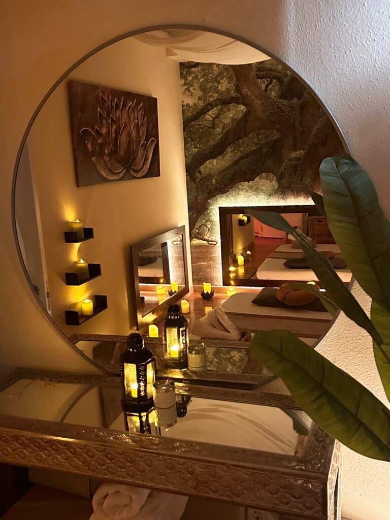 Candlelit dressing area with round mirror and lanterns at our Marbella centre