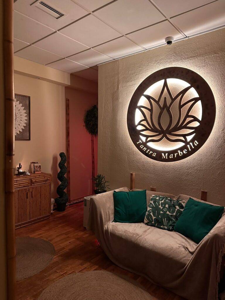 Relaxation lounge with sofa and illuminated lotus at Tantra Marbella