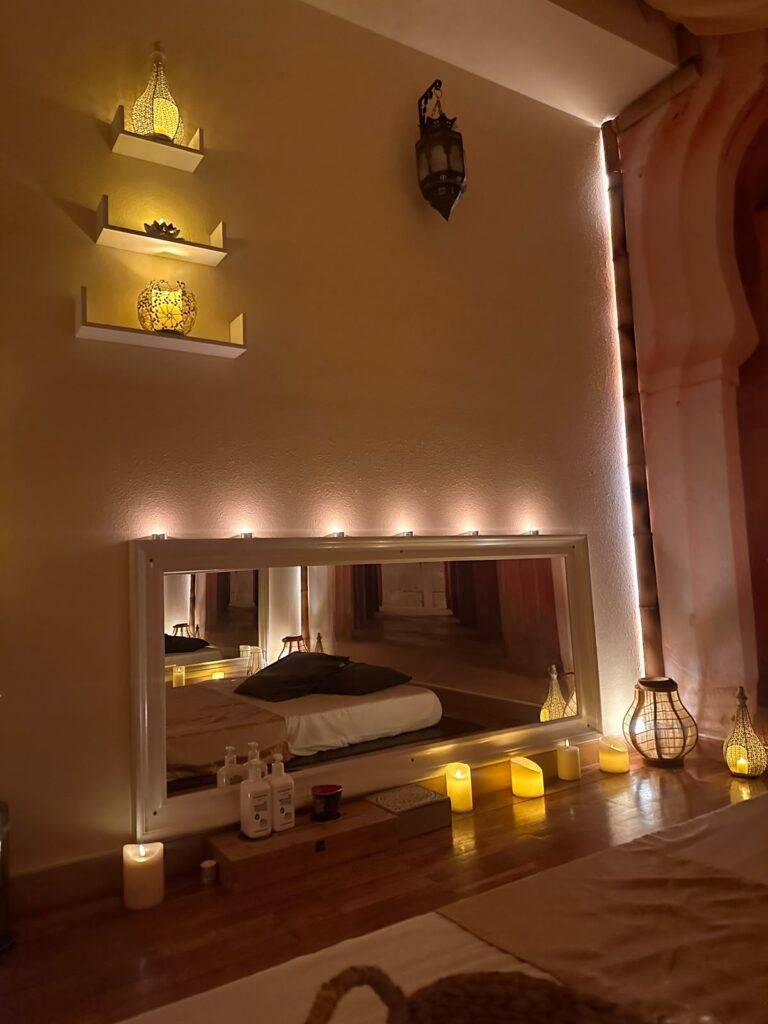 Softly lit massage room with candles in our Marbella centre