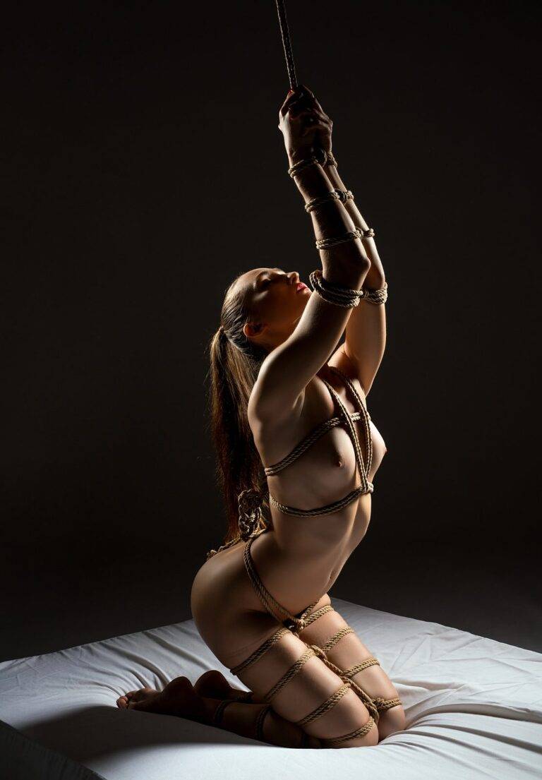Kneeling Shibari tie with suspension line at Tantra Marbella